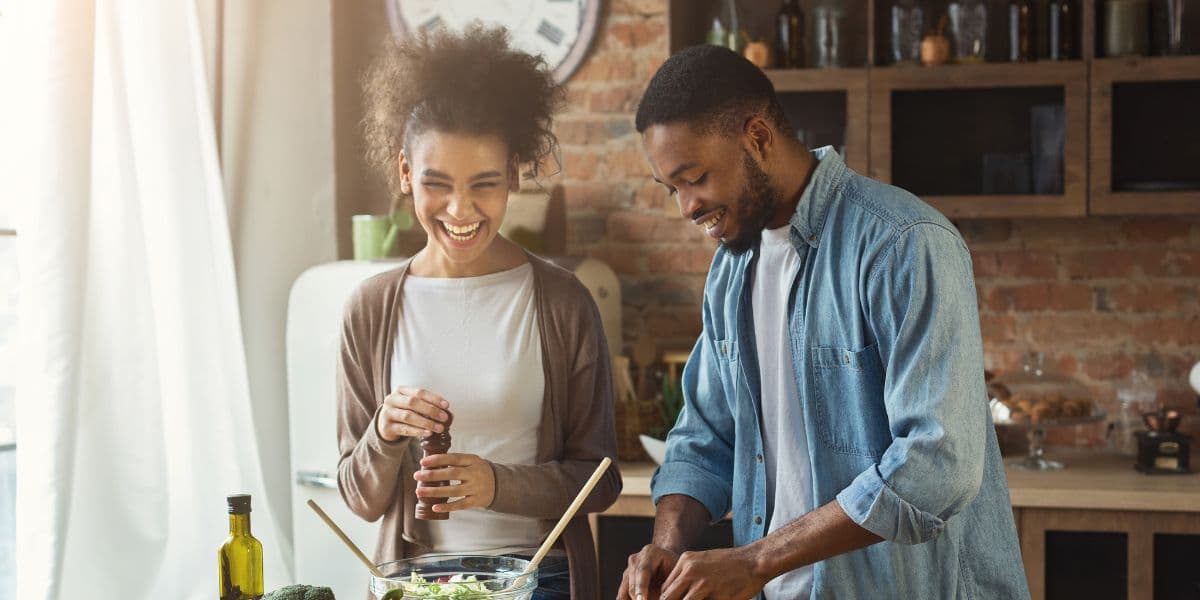 Confident happy couple cooking together